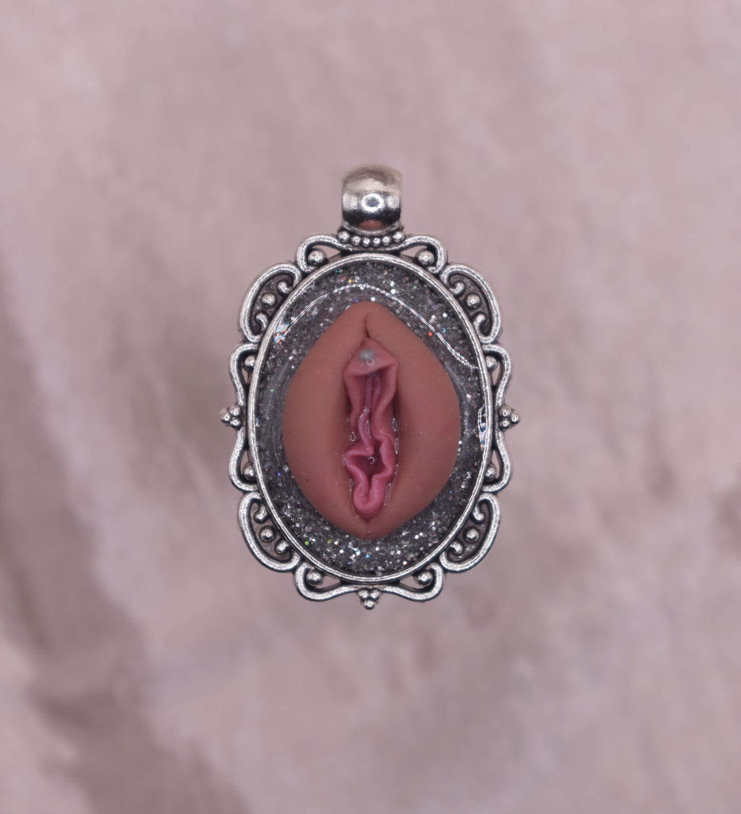 Silver pierced vagina pendant