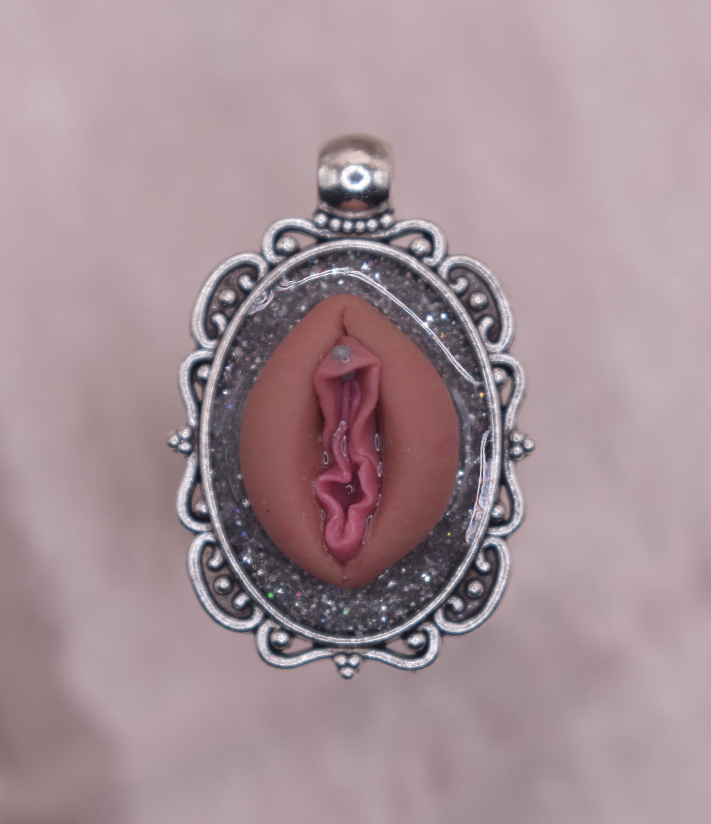 Silver pierced vagina pendant